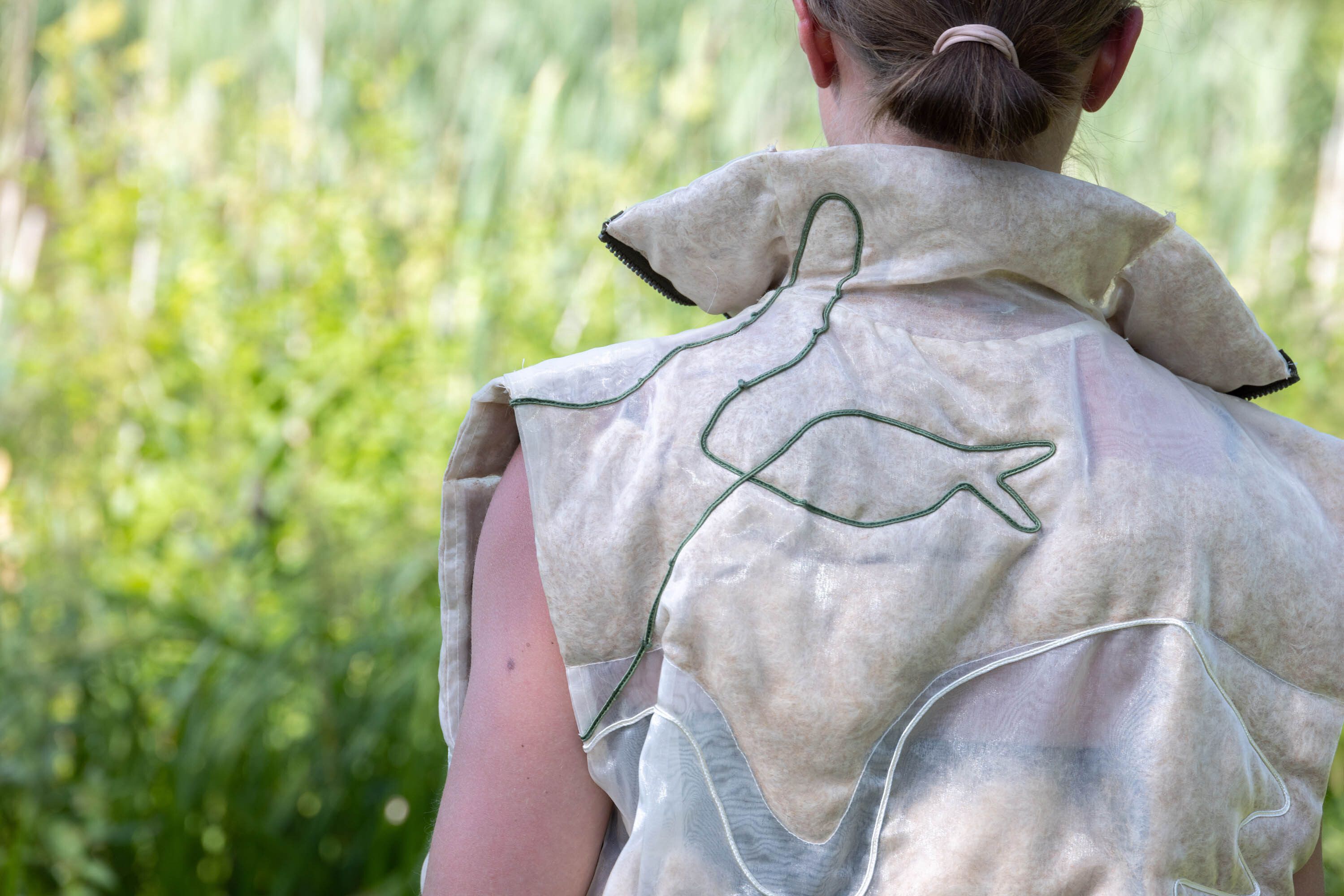 A detail of the back part of the vest or slipover.