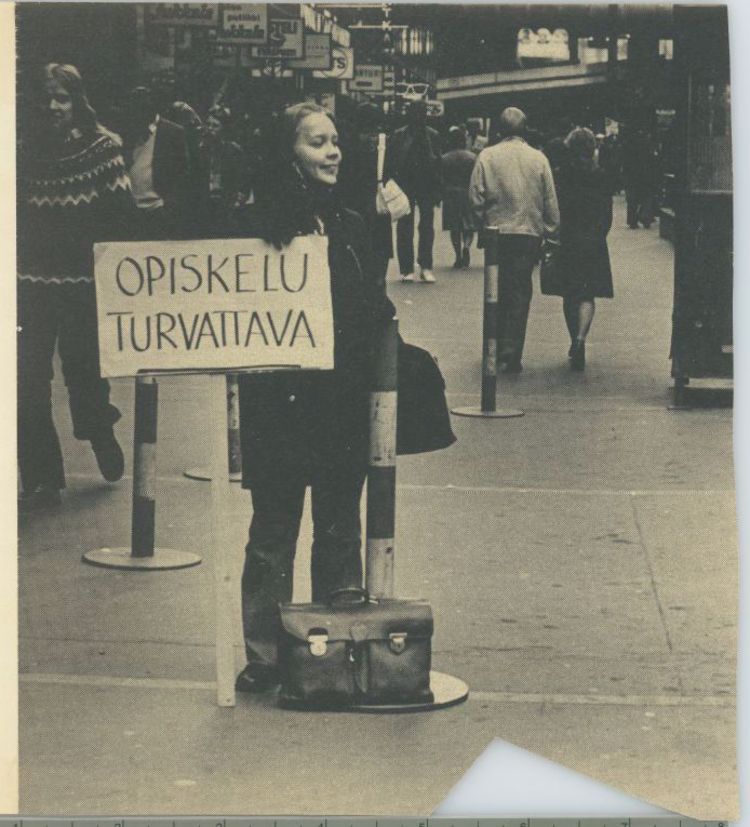 Student demonstrating on the street with a sign.