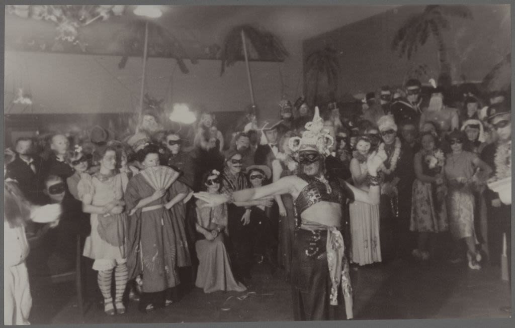 Dozens of people dressed up in costumes following a performance.