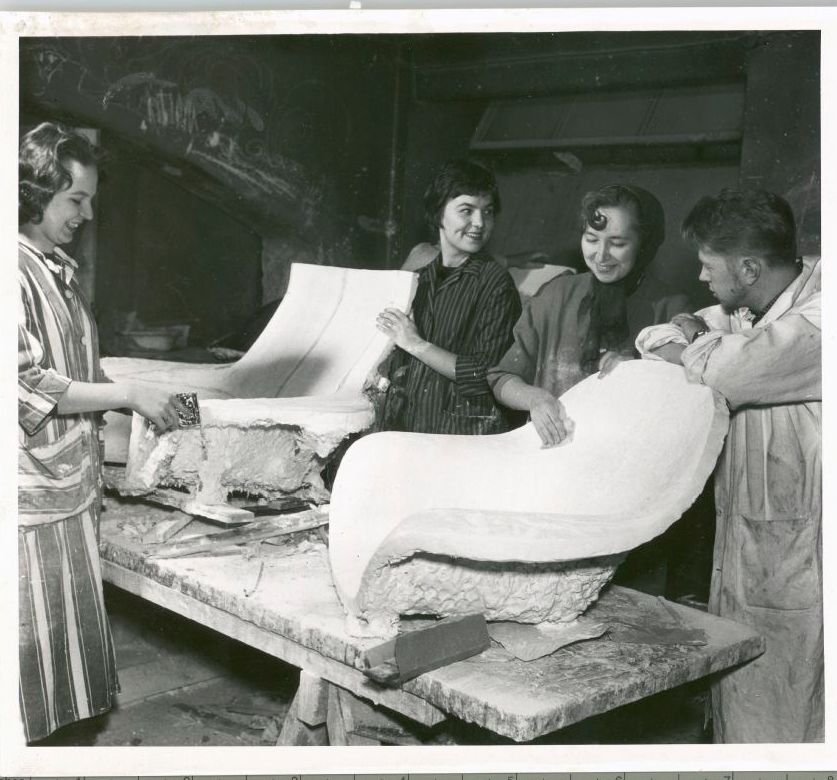 Four students pose together with two chair casts.