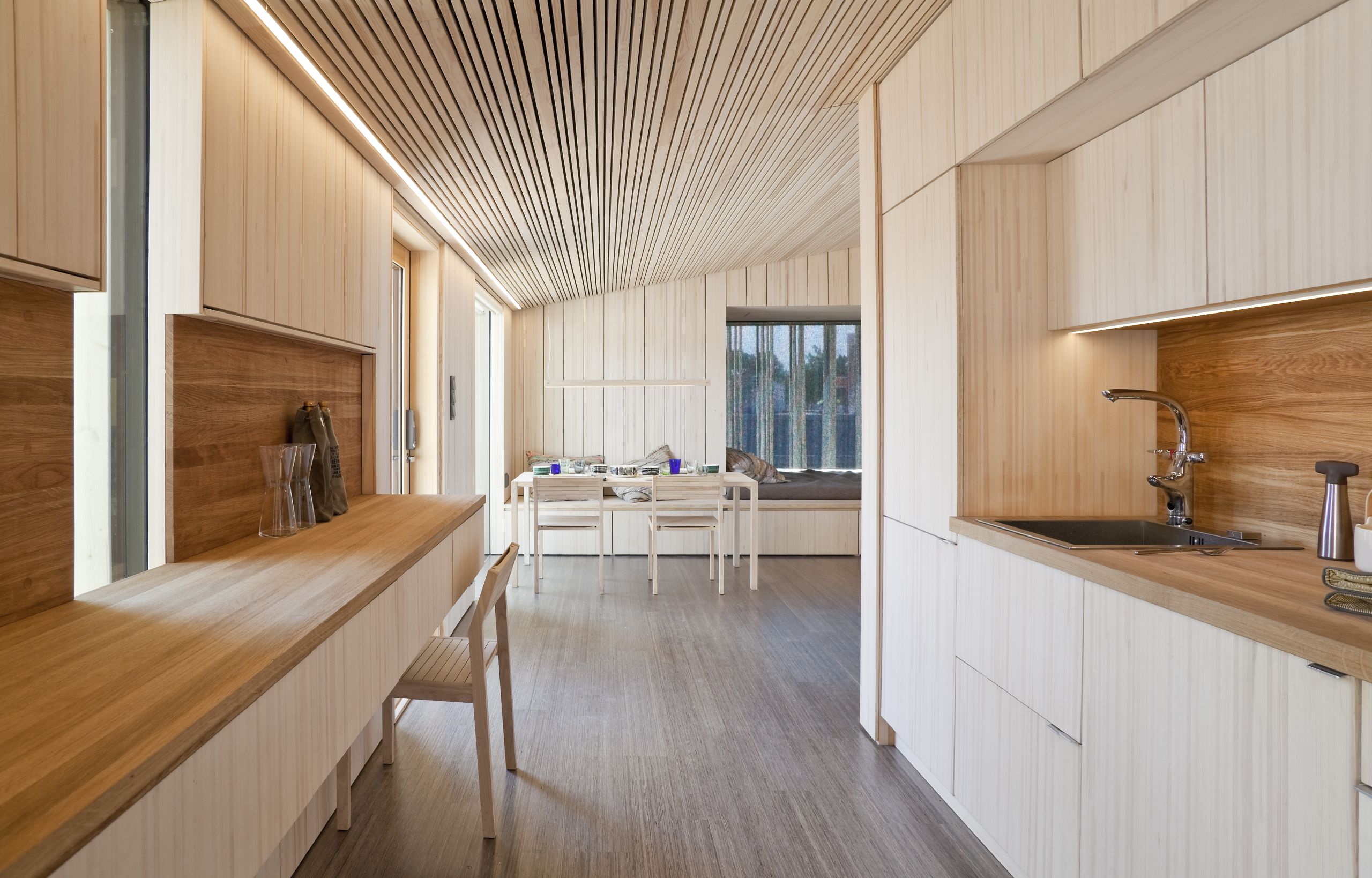 inside of wooden house from kitchen to dining area