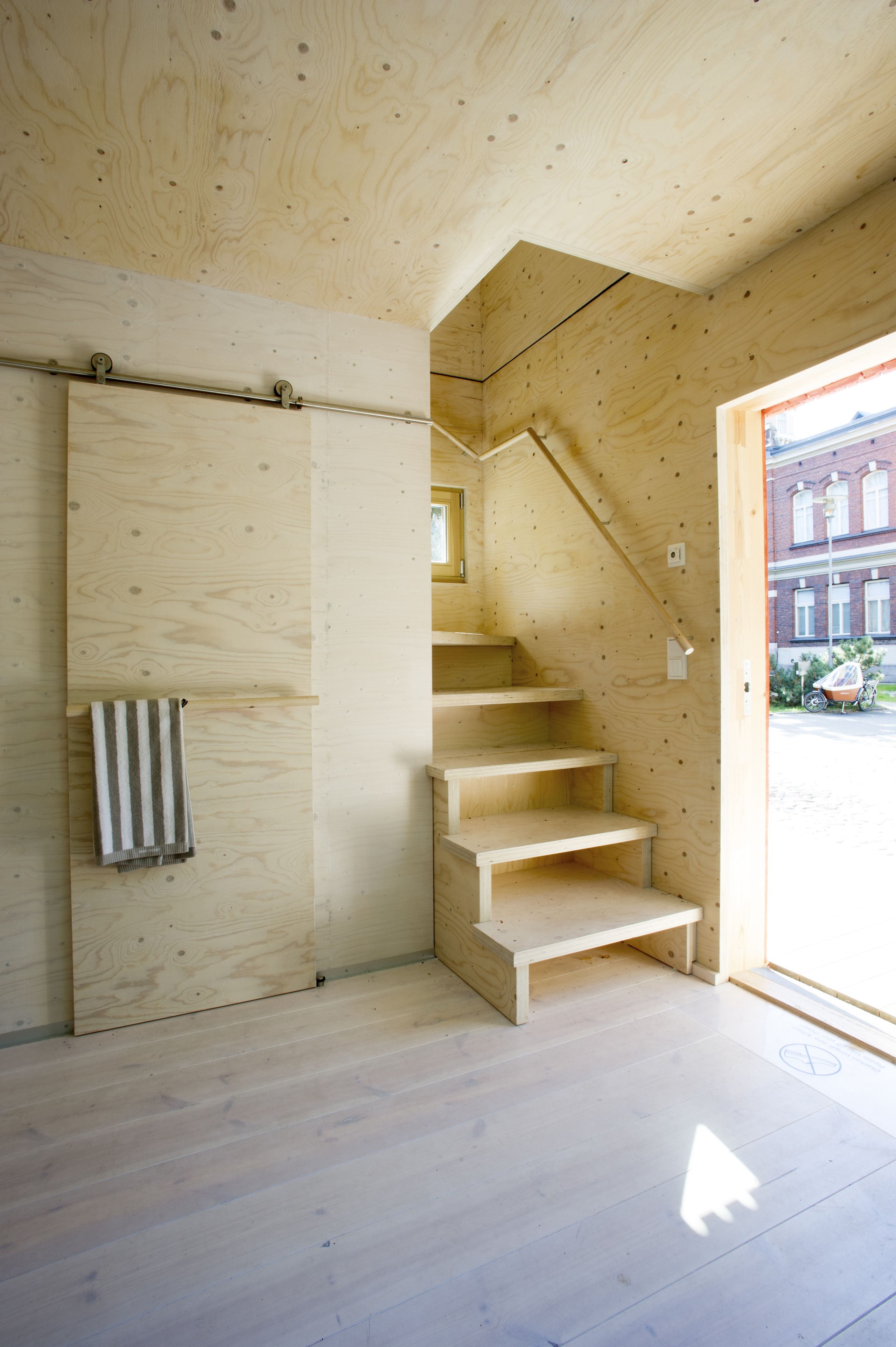 inside of wooden house picturing entrance and stairs