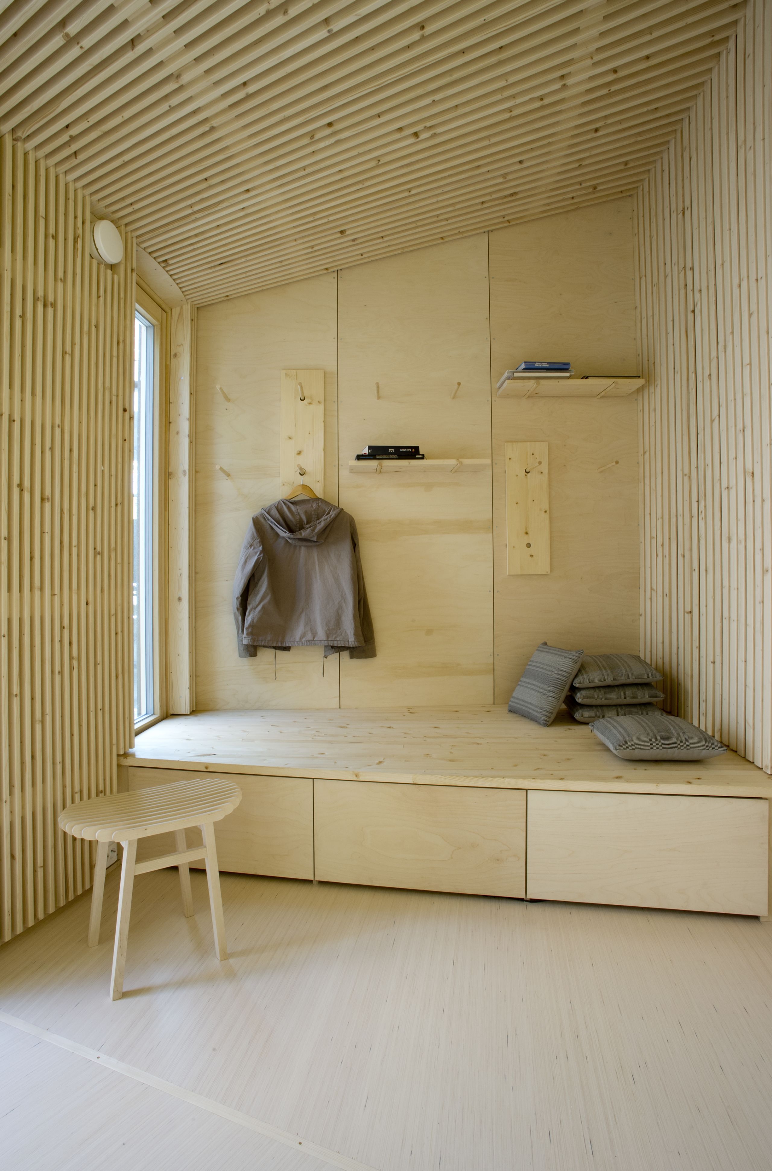inside wooden house with bench and wardrobe