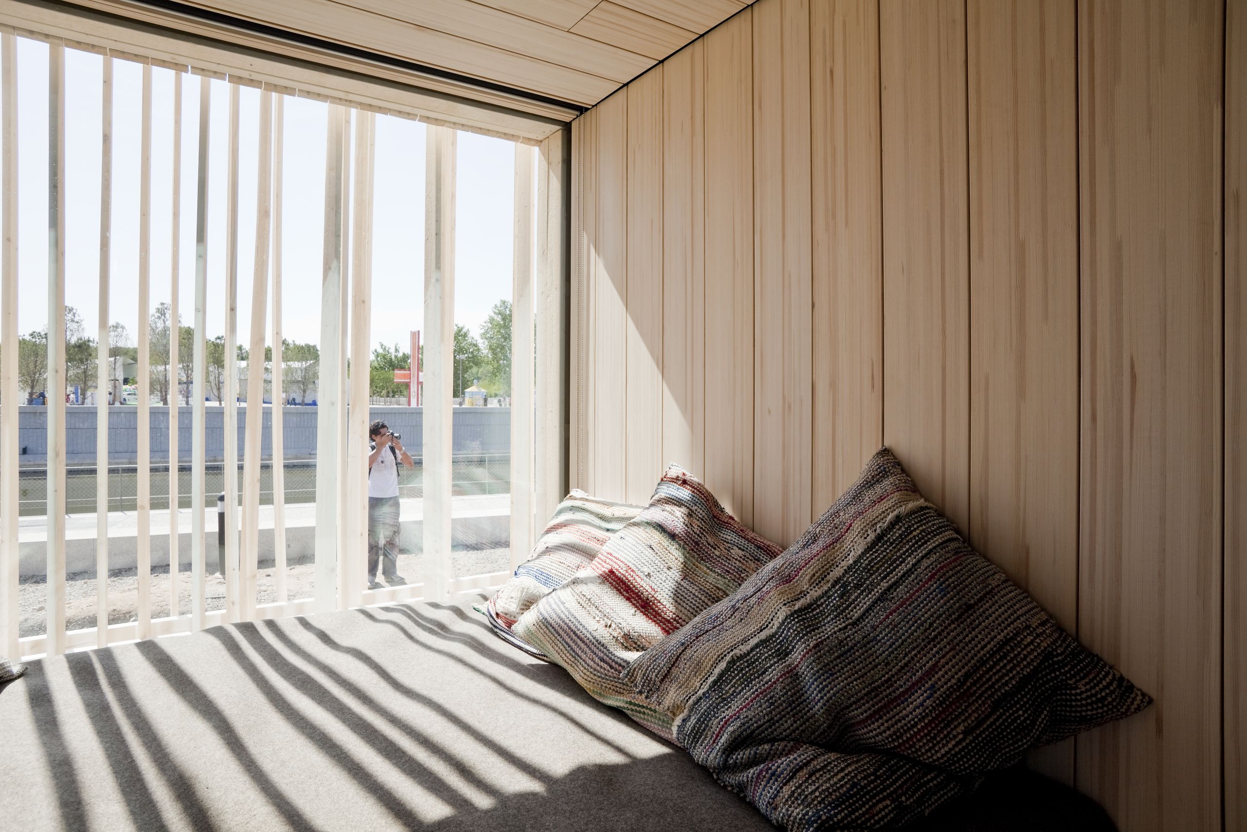 sleeping area with pillows by a sunlit window