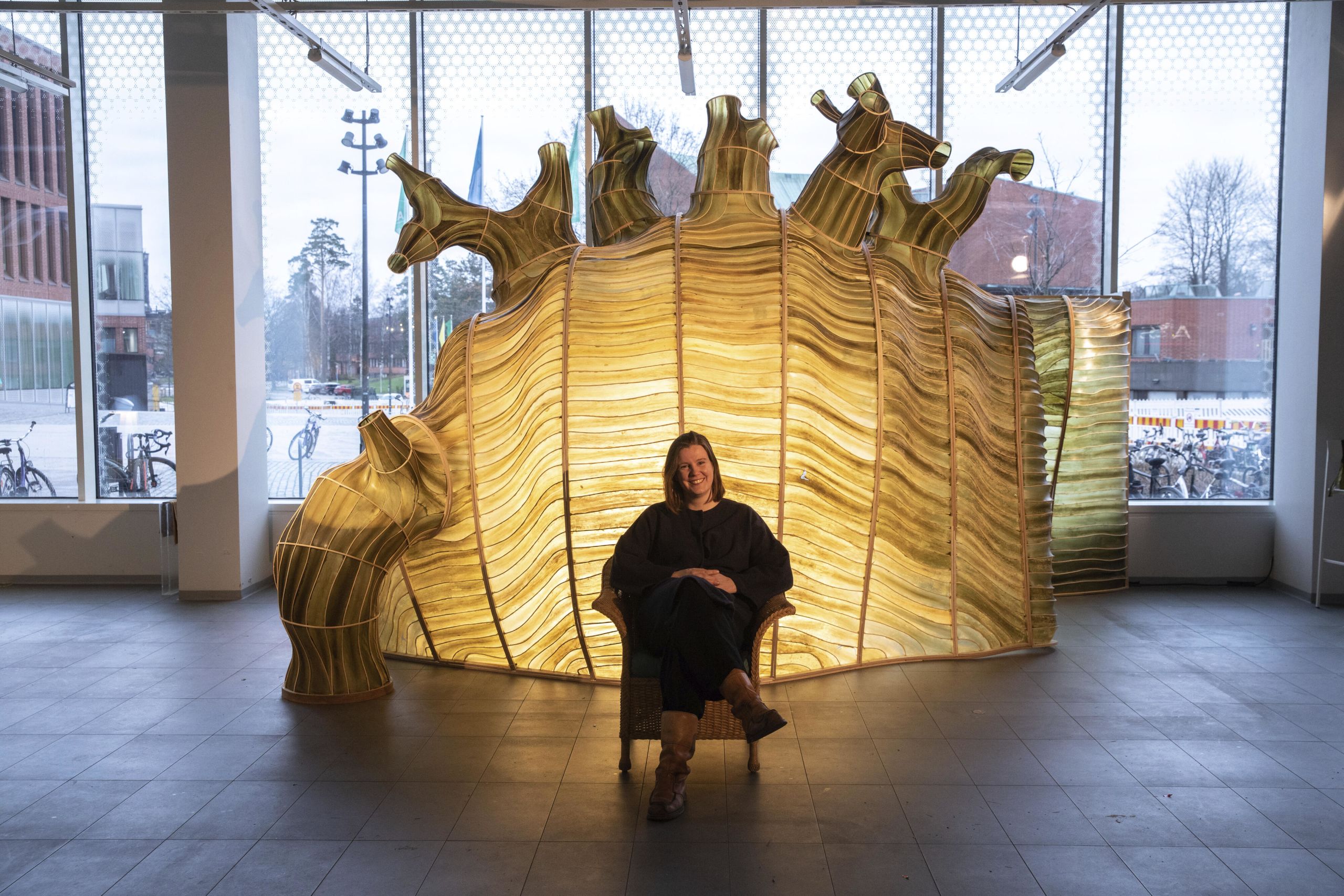 A seaweed pavilion lit up with researcher in the middle of the picture