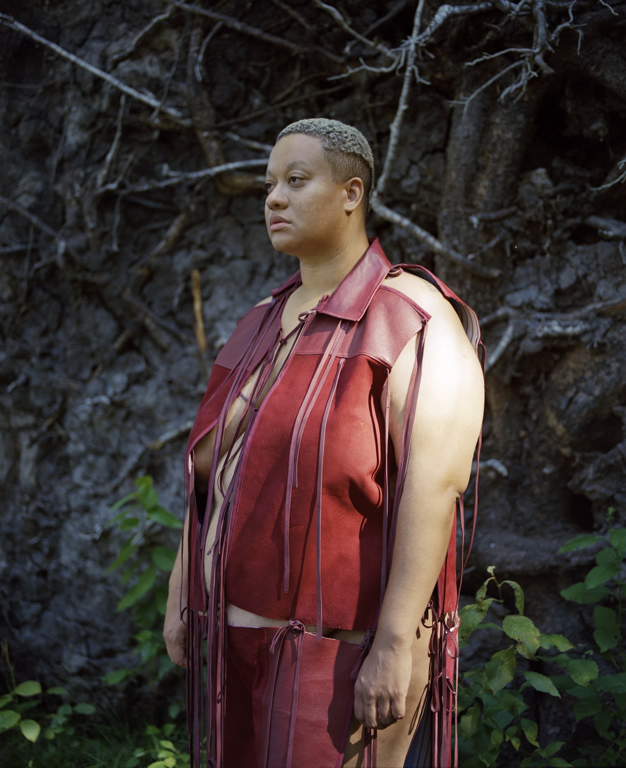 Brown curvy model wearing red garment in nature