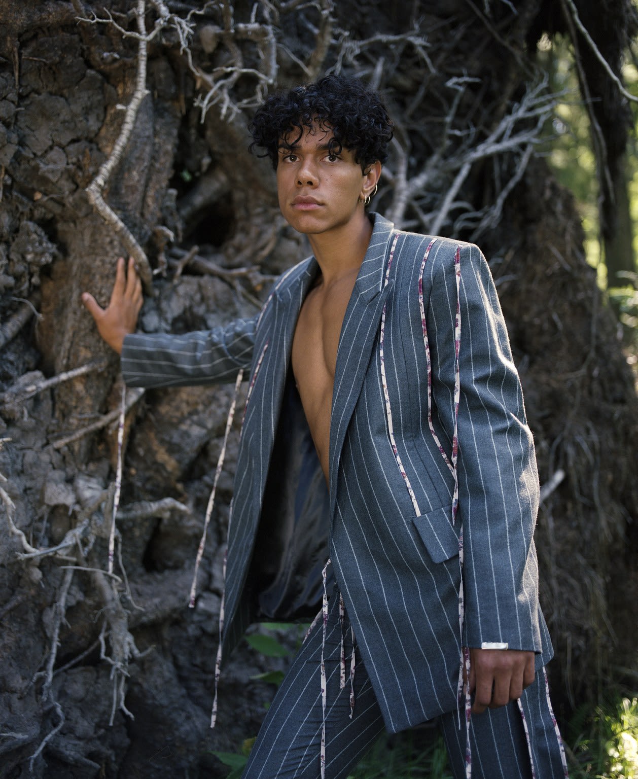 Brown model wearing blue garment in nature