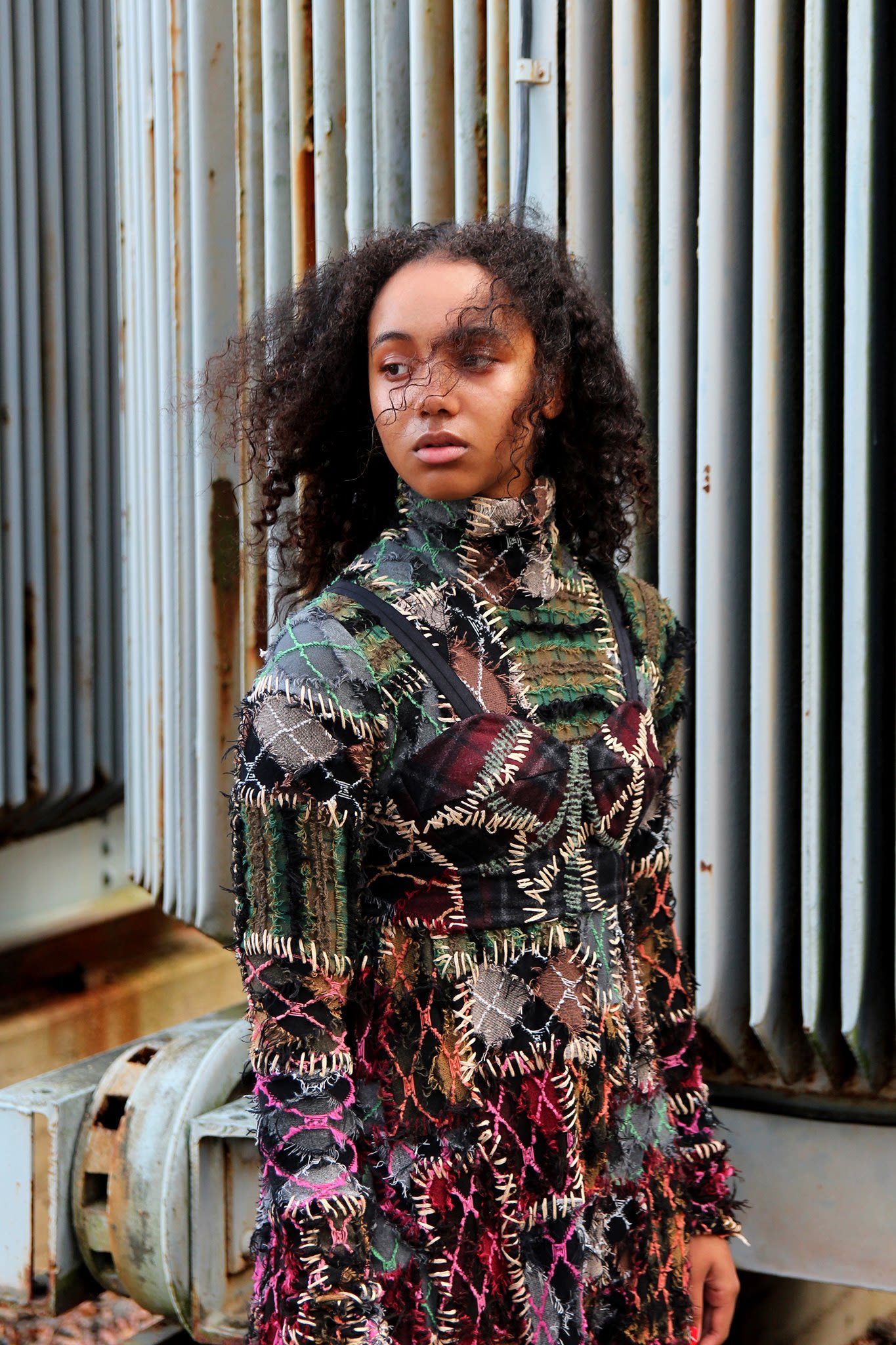 model wearing patched garment in several colors