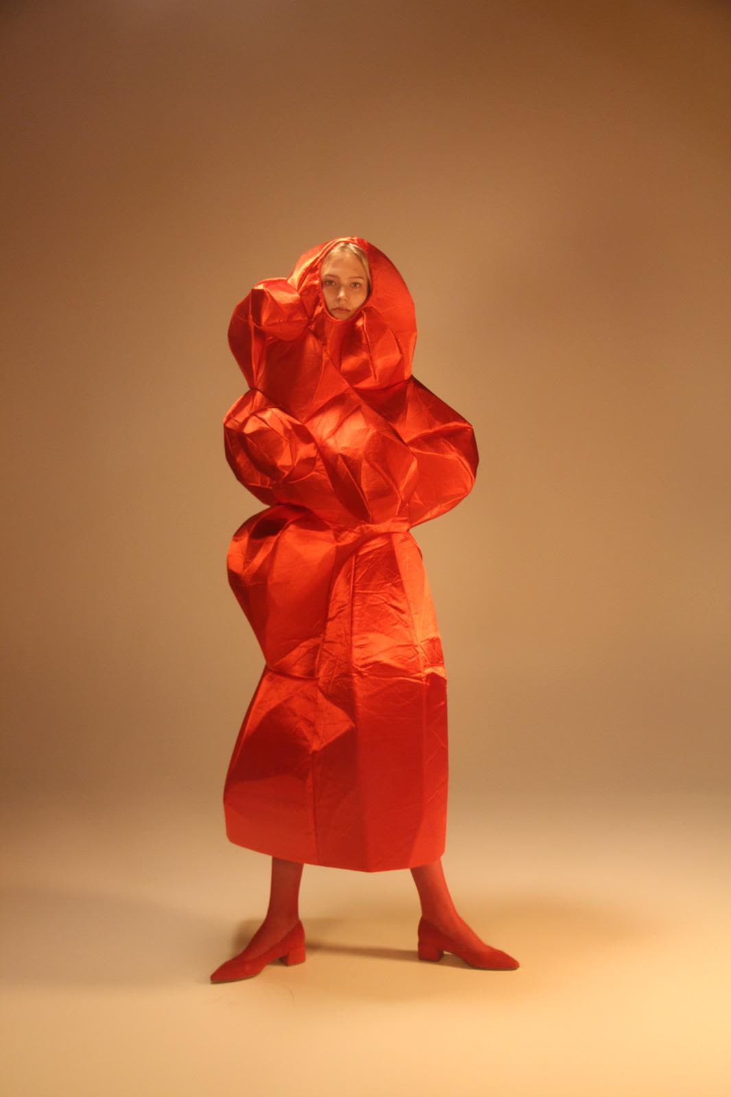 model wearing red sculpted dress