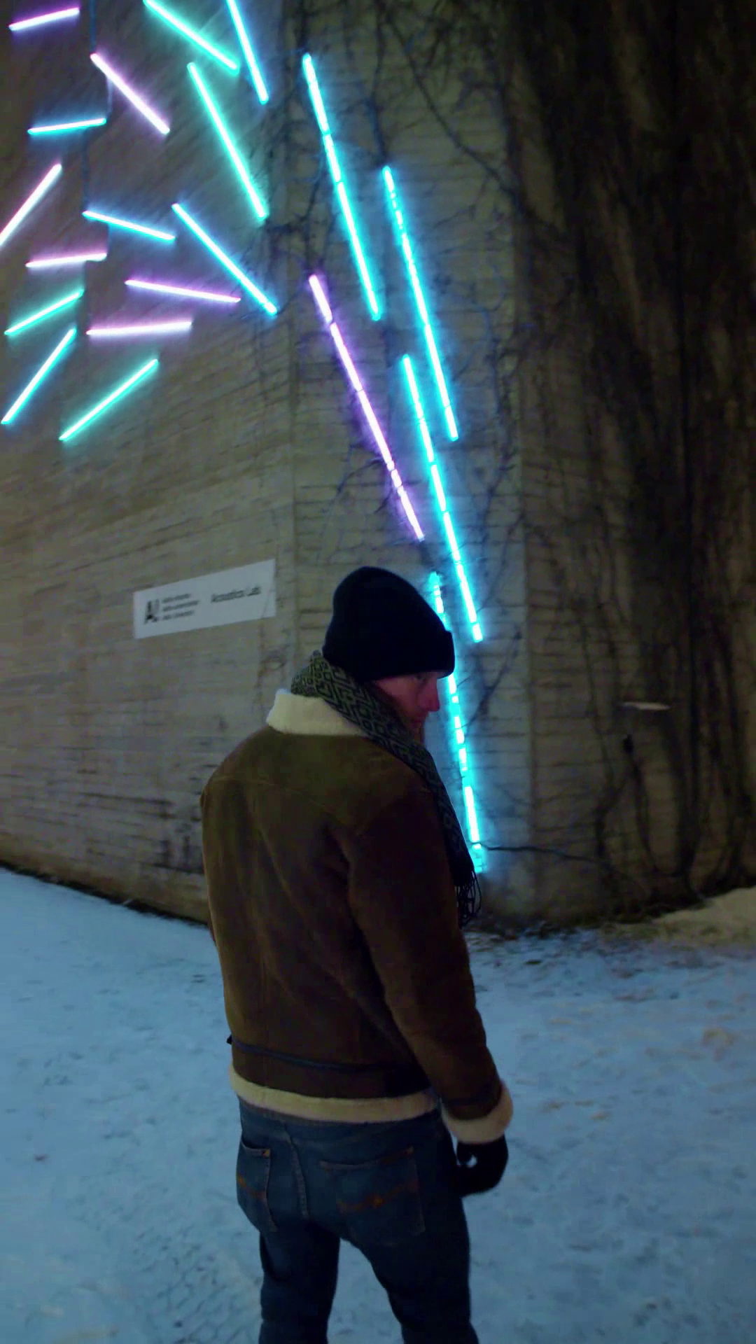 a man in the snow turning toward the camera