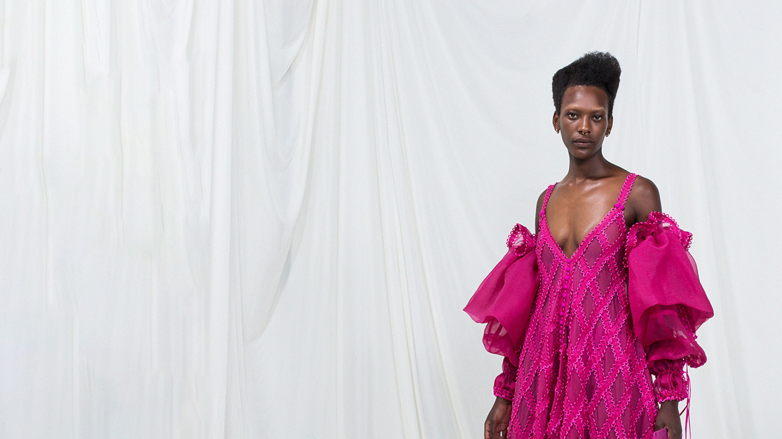 black person in pink modular dress
