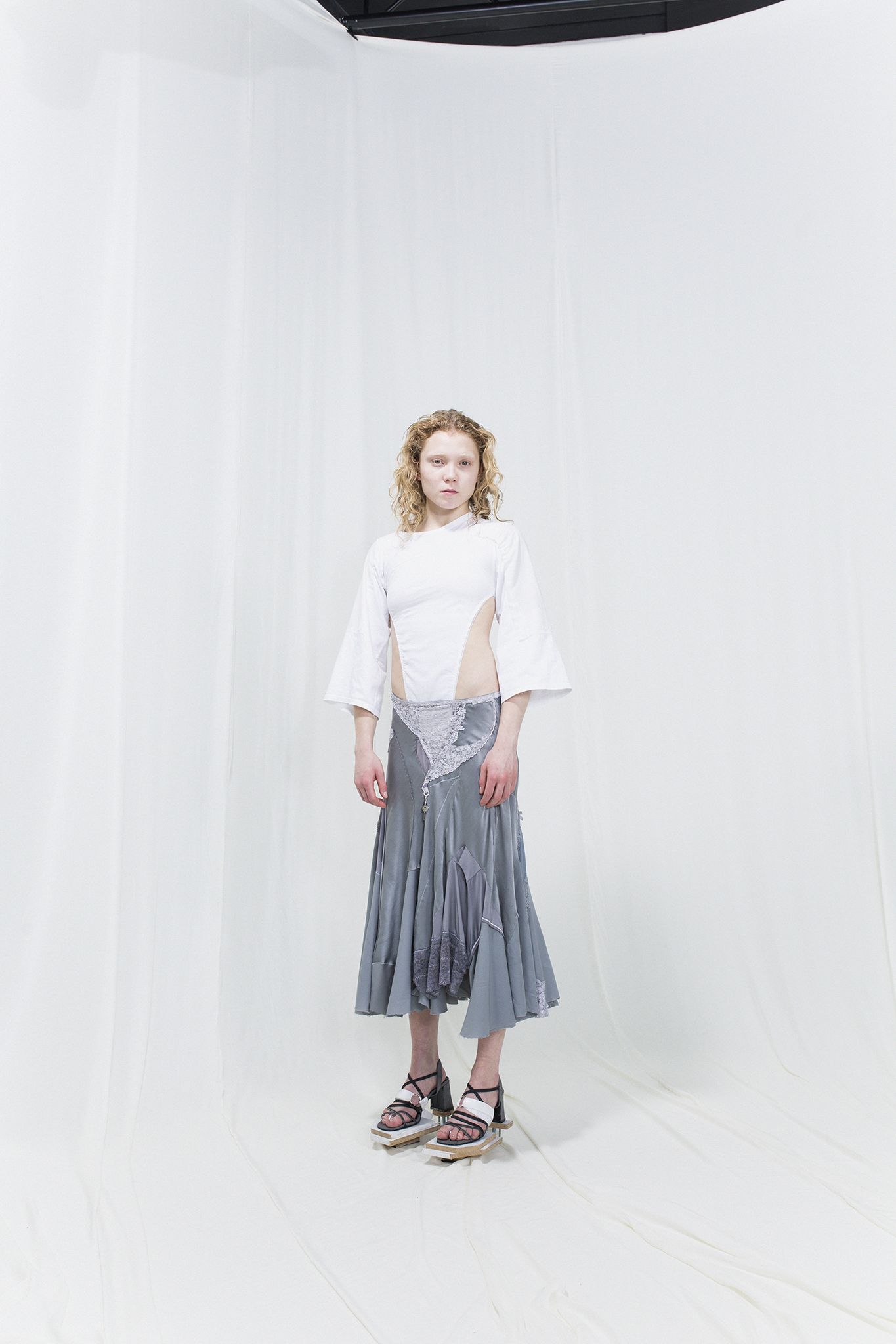 woman in white shirt and grey skirt